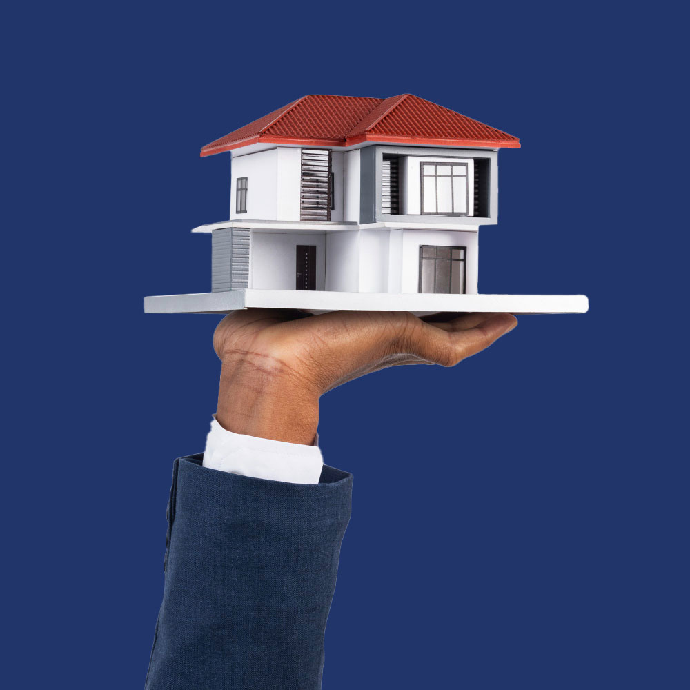 Hand holding a miniature house, representing property management